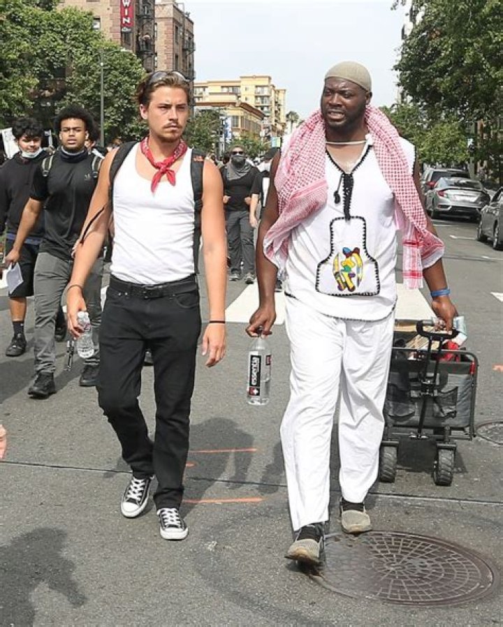 Cole Sprouse walks