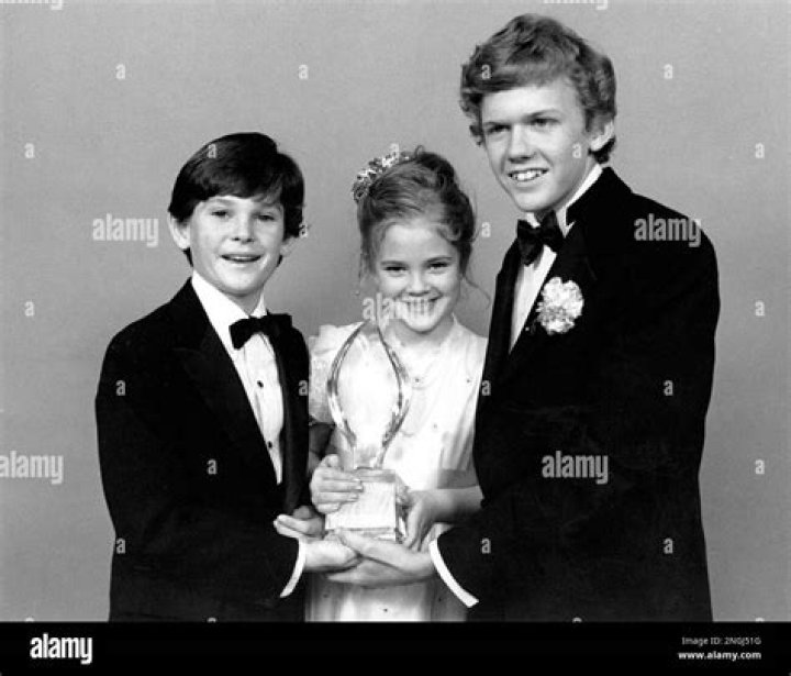 Drew Barrymore, center, Henry Thomas, left, and Robert Macnaughton, the young stars of Steven Spielberg's movie "E.T., The Extra-Terrestrial," pose with their People's Choice award after the movie was named favorite Motion Picture at the 9th annual People's Choice Awards in Santa Monica, Ca., on March 17, 1983. (AP Photo/Lennox McLendon)