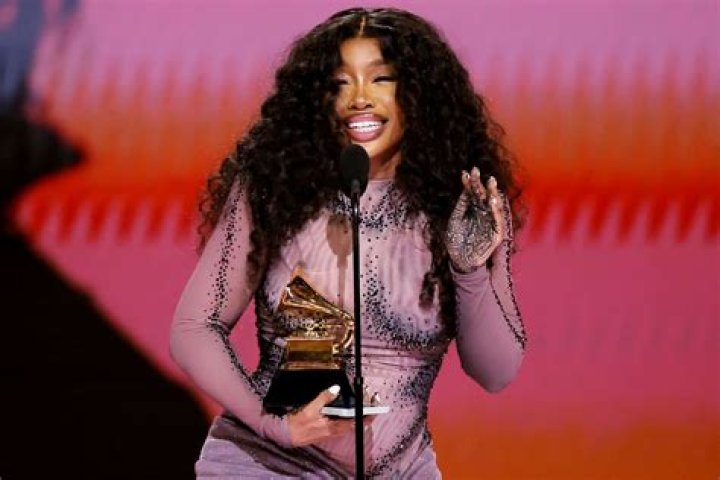 EXCLUSIVE: Singer SZA is all smiles at the beach in Hawaii as she celebrates chart-topping success with her new album 'SOS'. The 33-year-old hitmaker - real name Solana Imani Rowe - looked happy and relaxed as she hit the beach with her producer ThankGod4Cody, who is credited on seven songs on the history-making R&B album. She rocked a plunging pink halter neck swimsuit and matching sarong, also revealing a nip slip as she cooled off with a dip in the ocean. The New Jersey-raised R&B singer-songwriter is currently holding the top spot on the Billboard 200 with her long-awaited second LP. She recently took to Instagram, telling fans: "3 weeks at number one fully minding my business n not giving a f**k . Thank God." In her latest lyrics, the 'Hit Different' songstress has seemingly addressed plastic surgery rumors, responding to rampant speculation around whether her body has been cosmetically enhanced. 03 Jan 2023 Pictured: SZA. Photo credit: MEGA TheMegaAgency.com +1 888 505 6342 (Mega Agency TagID: MEGA929982_021.jpg) [Photo via Mega Agency]