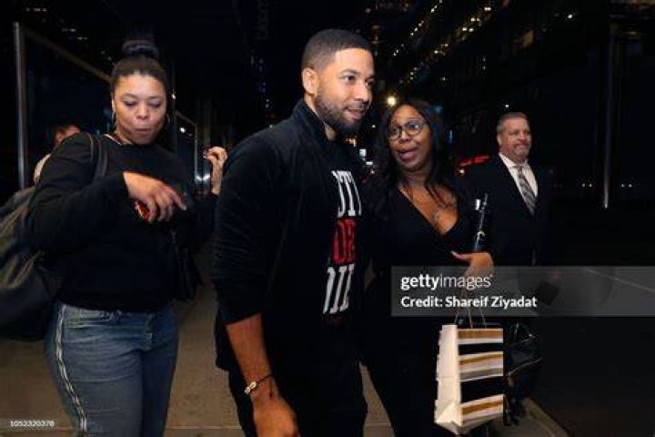 Jussie Smollett smiles at a magazine launch
