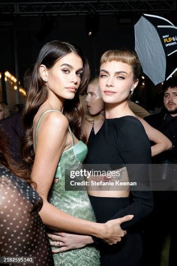 Kaia Gerber & Cara Delevingne holding each other